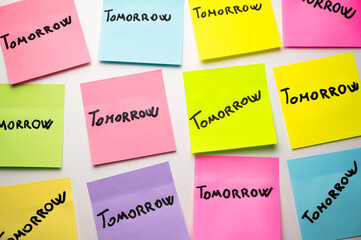 Colored cards, on which the word Tomorrow is written. Habit of procrastinating and postponing.