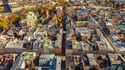 Fototapeta premium Colorful roofs of buildings in old district of Krakow, Poland, from bird's eye view. Drone photo.