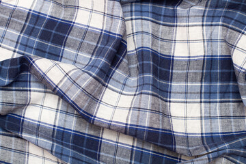 A blue and white checkered fabric in a close up view