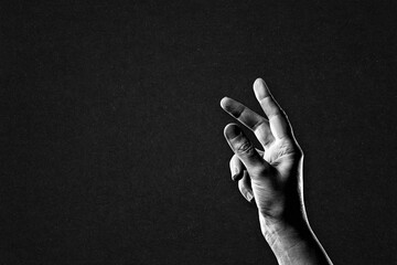 Hand Reaching Sign in Black and White on Textured Paper Background, Copy Space