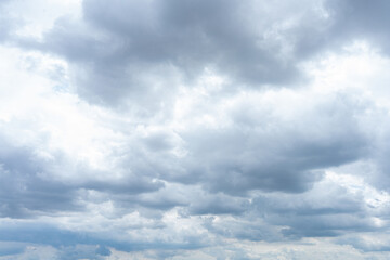 Obraz premium Fluffy cumulus clouds drift across a vibrant blue sky