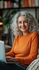 Middle-aged woman smiling while looking at computer, surfing the internet, shopping online.