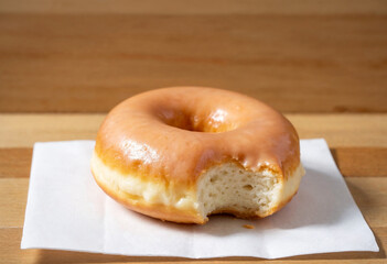 Glazed Donut with a Bite on a Napkin