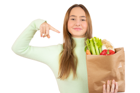Young girl holding a bag of freshly bought vegetables on a transparent background. PNG transparent.