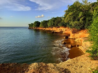 scenic coast in saint Rose near pointe allegre and anse des iles beach, with pink rocks in sunset...