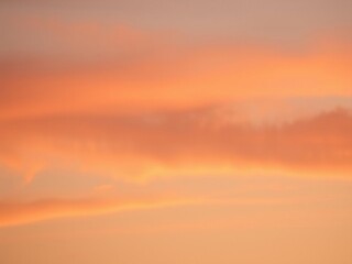 Fototapeta premium delicate orange and peach tones blend in the sky, pastel sunset, gentle gradient, warm color palette
