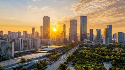 Fototapeta premium Stunning sunset over a modern city skyline with green parkland.