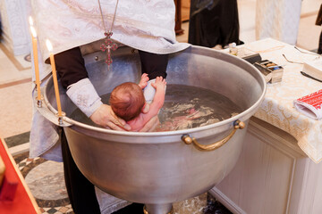 Traditional Baptism Ceremony with Infant in Holy Water