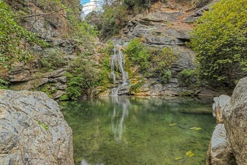 Ucelluline waterfalls on Corsica surrounded by lush greenery and rocks, showcasing natural beauty