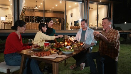 Family holding sparkler in holiday celebration dinner party. Family member enjoy play spark...