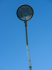 Artistic Low-Angle Shot of a Street Lamp Against a Clear Blue Sky