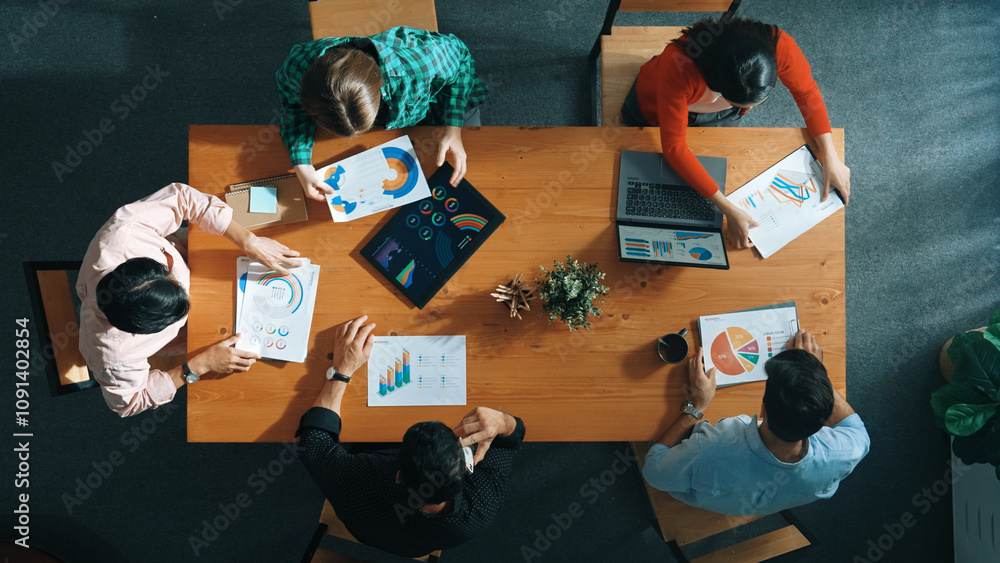 Poster top down view of manager holds tablet display increasing sales and placed on meeting table. group of