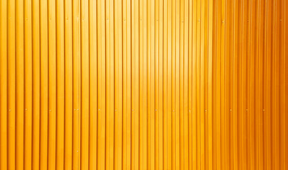 real chrome yellow corrugated metal sheet wall showing vertical pattern, bolts, screw. modern...