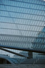 Showcasing innovative architectural design featuring large glass facades and steel structures reflecting contemporary urban setting. Emphasizing clean lines and geometric patterns