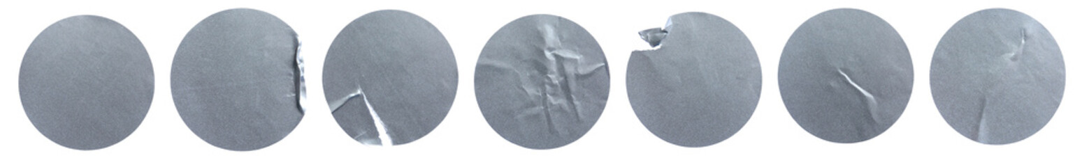 A set of blank silver grey round adhesive paper sticker label isolated on white background.