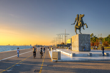 Alexander the Great Statue on the Waterfront Promenade During a Vibrant Sunset with People Enjoying...