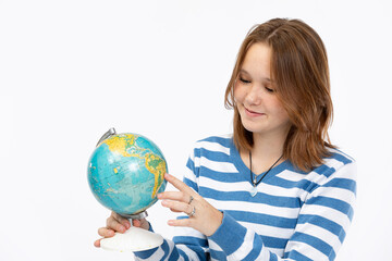 Fototapeta premium Exploring the Vast World A Young Girl Engaging with a Colorful Globe and Learning