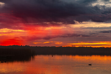 A stunning sunset reflection seen over the calm water, creating a beautiful scene