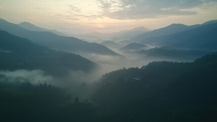 Fototapeta premium Mountain Range with Mist at Sunrise