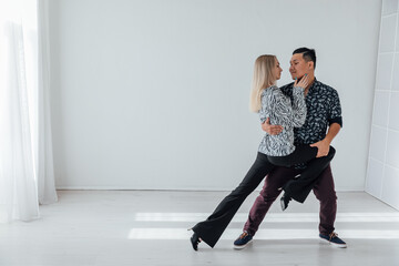 Man and woman dancing together to bachata music