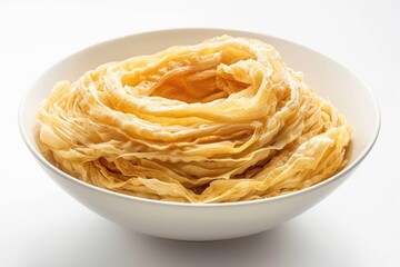 A white bowl filled with pasta sits on a table, perfect for a meal or snack