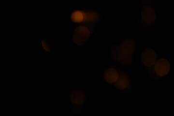 Red and fire orange bokeh on a black background, bokeh abstract background, modern abstract backdrop. Orange Christmas background, Xmas backdrop. Halloween scary concept, Halloween bokeh background

