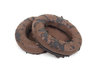 broken headphone pad from frequent use isolated on a white background