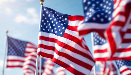 Obraz premium Close-up of American flags waving in the wind, showcasing patriotism and celebration.
