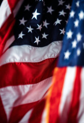Close-up of American flags waving in the wind, showcasing patriotism and celebration.


