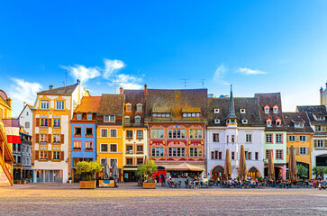 Mulhouse cityscape, typical houses colorful buildings and street restaurant outdoor café on Place de la Reunion square in old town Mulhouse city historic centre, Alsace Grand Est region, France