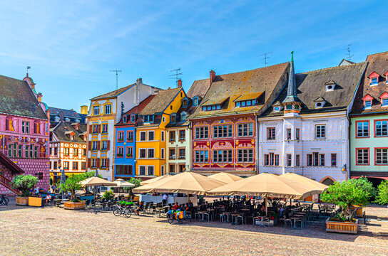 Fototapeta Mulhouse cityscape, typical houses colorful buildings and street restaurant outdoor café on Place de la Reunion square in old town Mulhouse city historic centre, Alsace Grand Est region, France