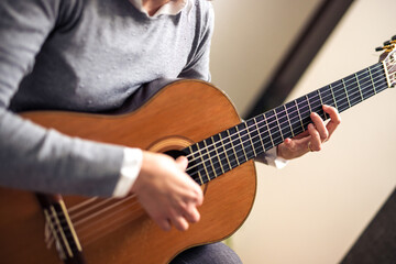 Obraz premium Mature Woman Playing Guitar At Home