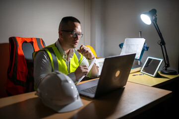 A structural engineer is sitting at his desk trying to complete a building structure design at...