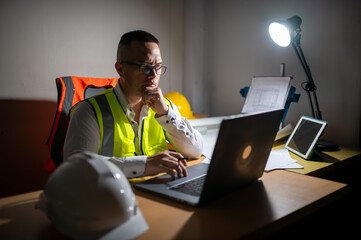 A structural engineer is sitting at his desk trying to complete a building structure design at...