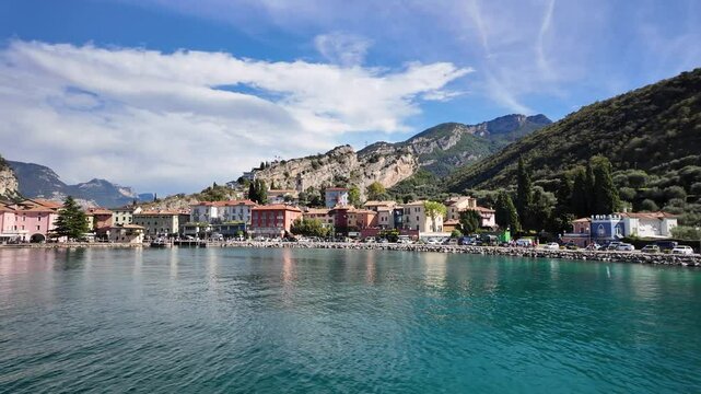 Panoramic view of Lake Garda and the town of Torbole on a sunny day, Italy. View from the lake.