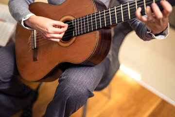 Obraz premium Mature Woman Playing Guitar At Home