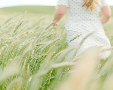 Woman running through lush wheat field nature lifestyle outdoors freedom serenity
