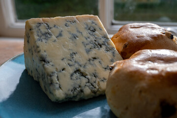 Cheese collection, English cow milk semi-soft, crumbly old stilton blue cheese and baked scones buns