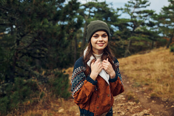 Beautiful young woman wearing a beanie enjoying nature in the forest Travel, fashion, beauty, portrait art concept