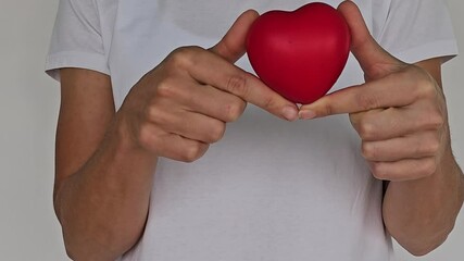 Woman holding red heart on white background 