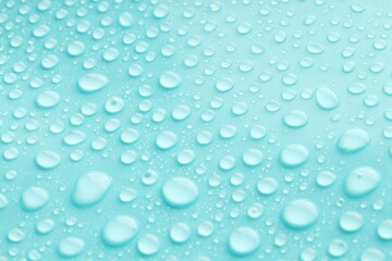 Water drops on turquoise background, closeup view