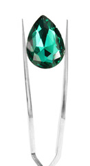 Tweezers with shiny turquoise gemstone isolated on white