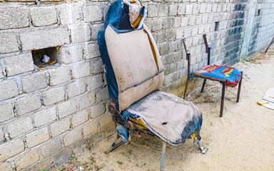 Old broken car seat outside for sitting in Mexico.