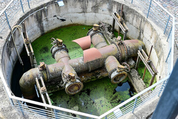 Large water pumping station and water distributor in a septic tank, round concrete shaft of a sewage treatment plant in Latvia