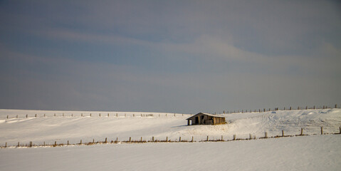 hut in landscape with snow