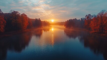 Fototapeta premium Autumn Sunrise Over Misty River And Colorful Trees
