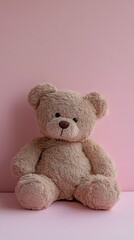 Obraz premium Adorable Plush Teddy Bear Sitting on a Pink Background