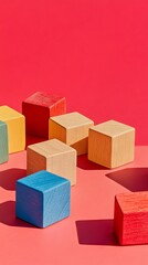 Obraz premium Colorful Wooden Blocks on Red Background - Minimalist Still Life