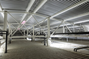 Attic space with utility lines. Metal trusses covering an industrial building.