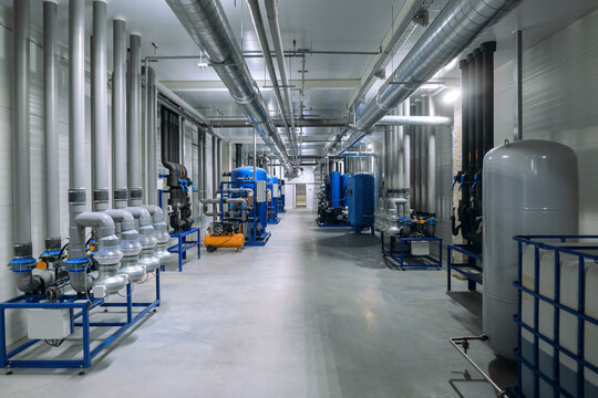 System for monitoring and maintaining temperature and humidity in production and storage facilities. Hall with industrial equipment.